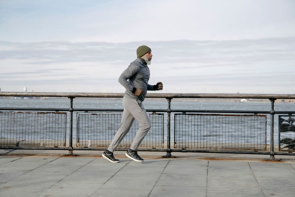 Person running along the waterfront in the early morning