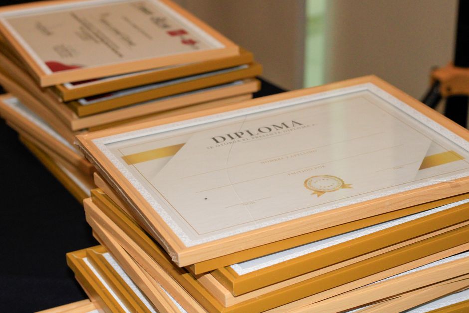 A stack of framed diplomas prepared for an academic ceremony