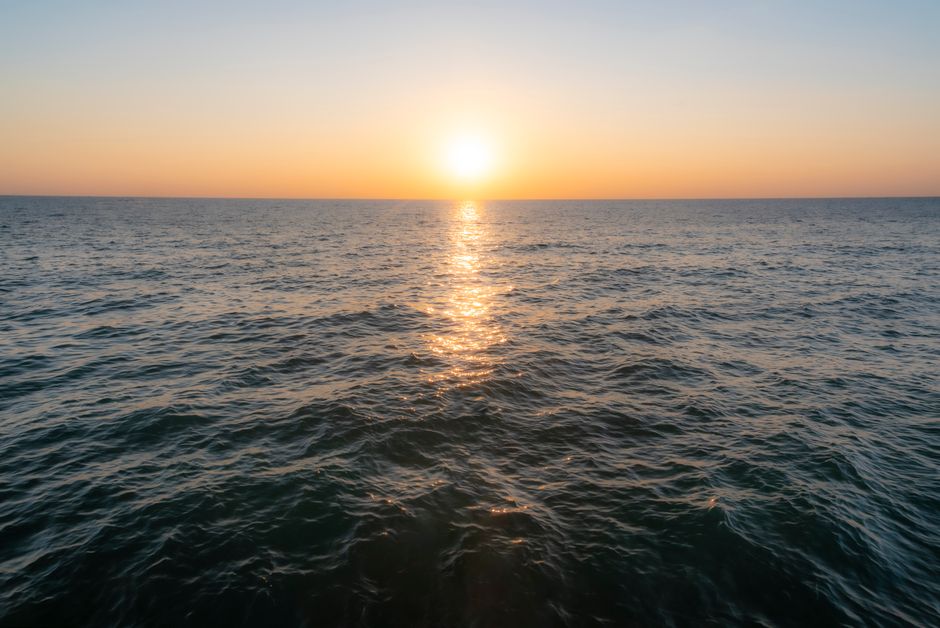 Sunlit open ocean water surface representing the seawater source for brine-free solar desalination research