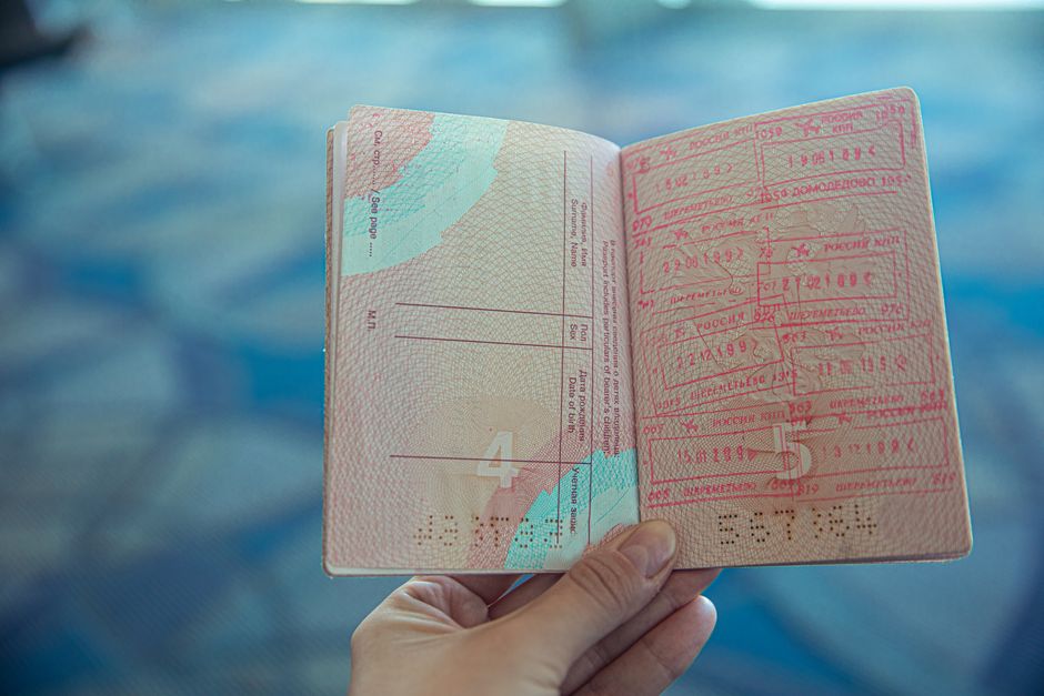 Open passport with official stamps illustrating document authentication for US visa applications